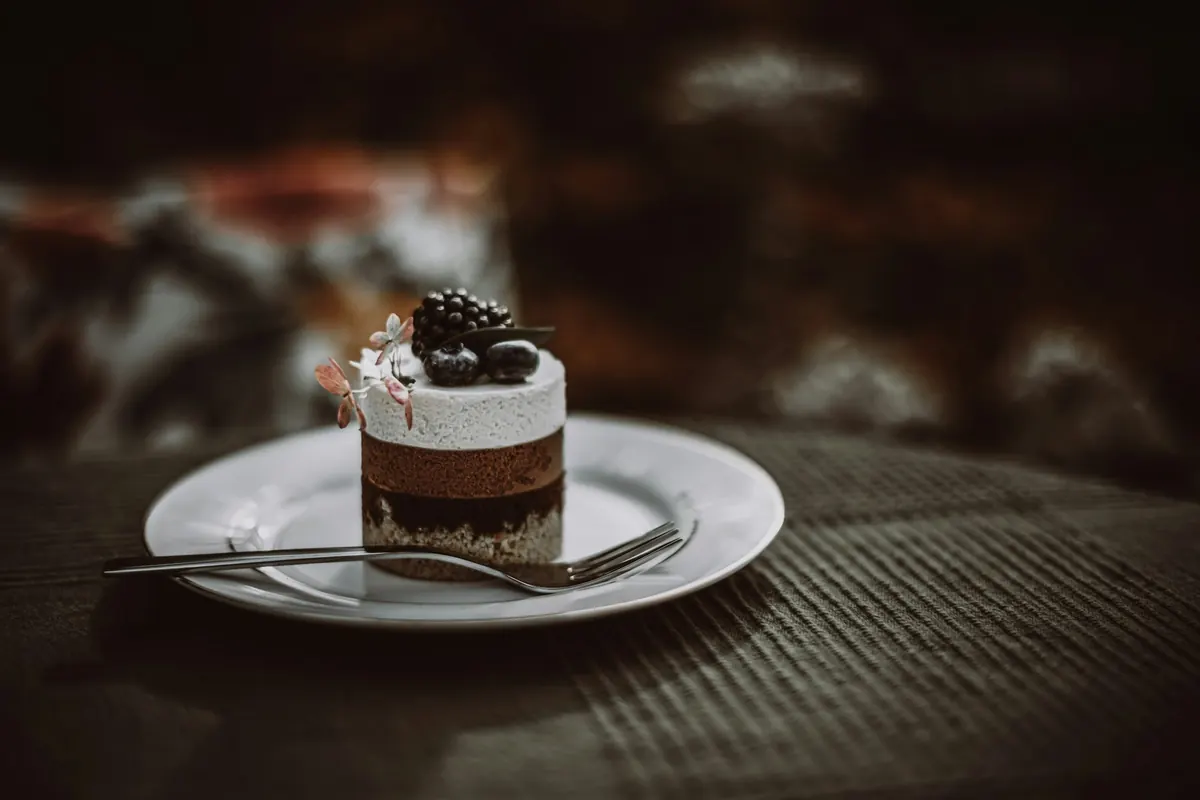 A chocolate mousse cake topped with blackberries